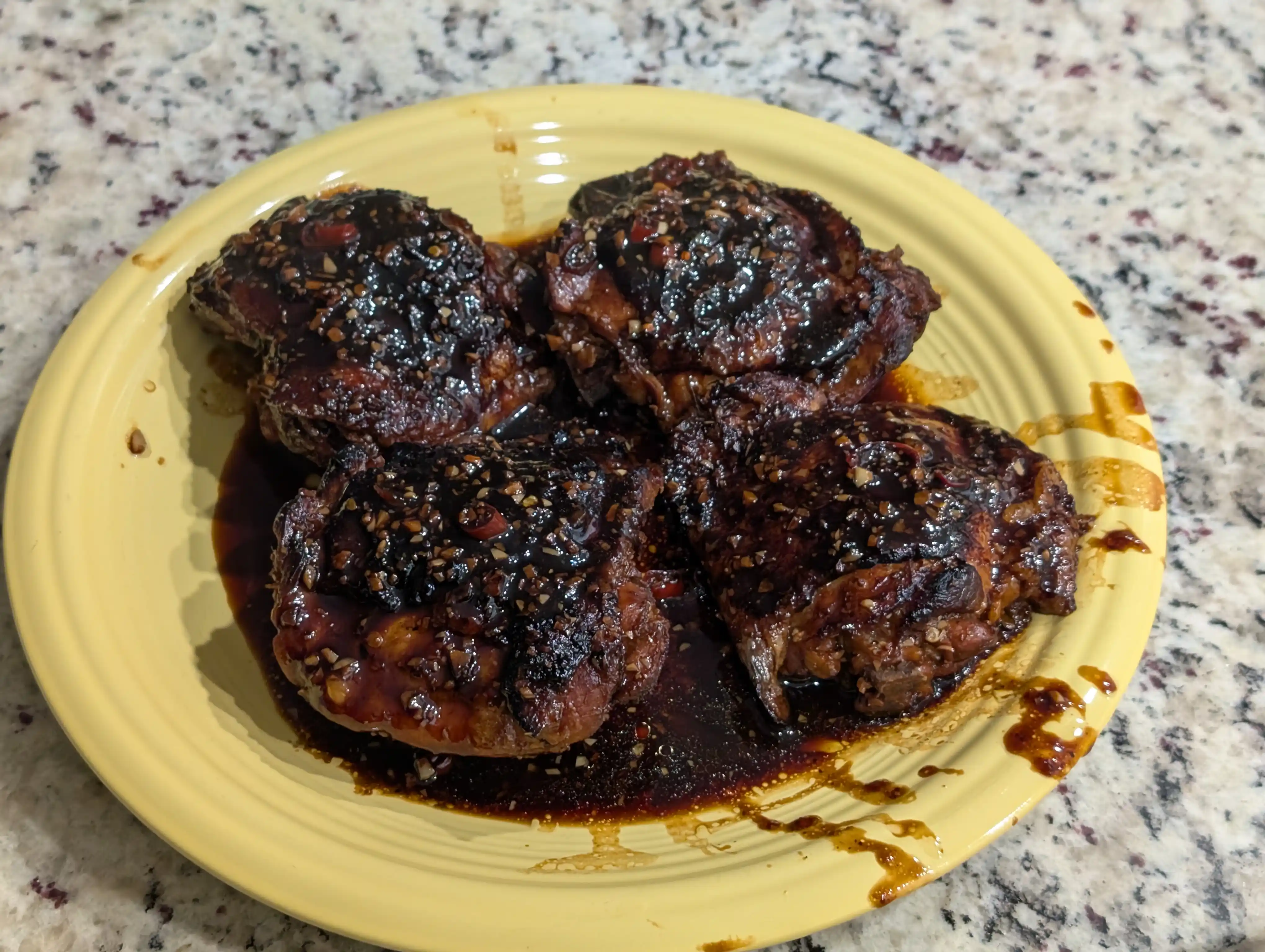 Plate with chicken adobo made from chicken thighs