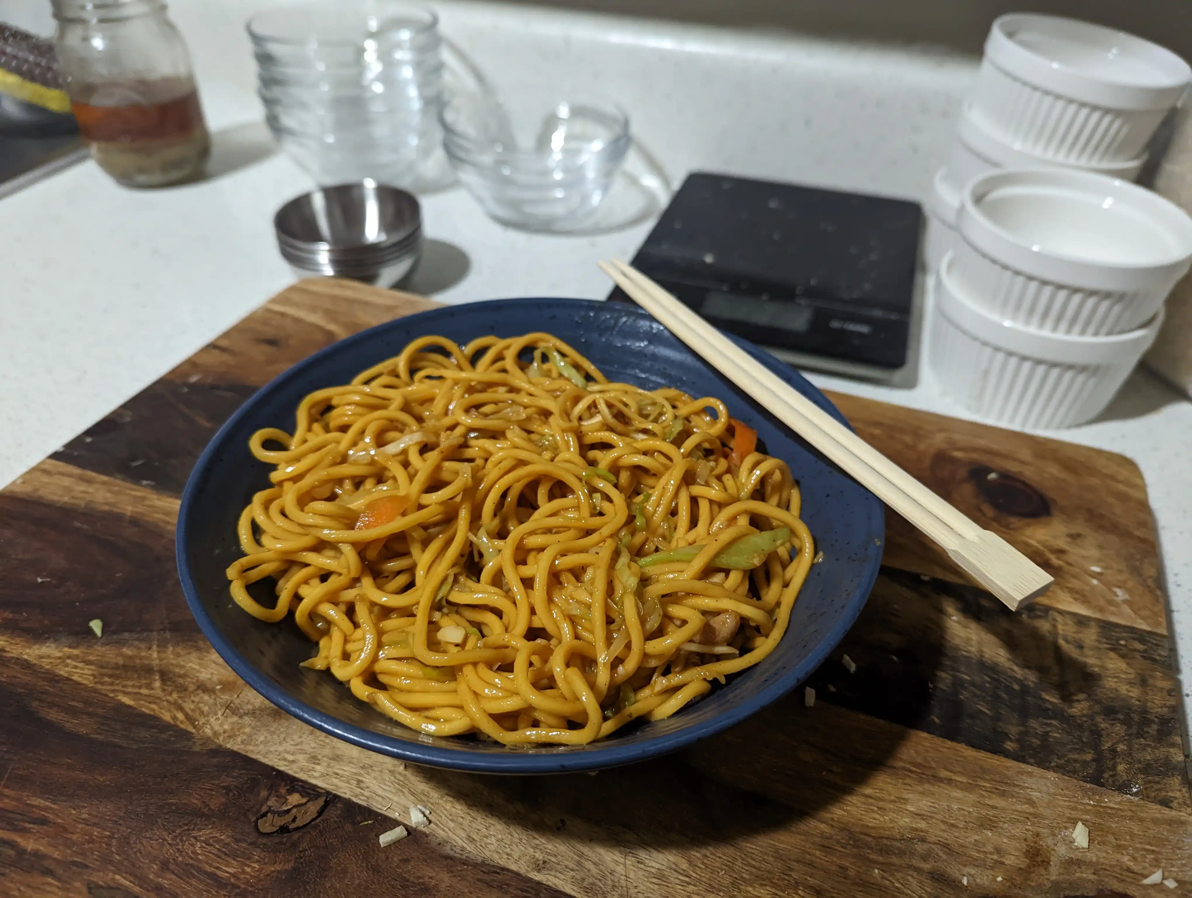 Bowl of chow mein with chopsticks.