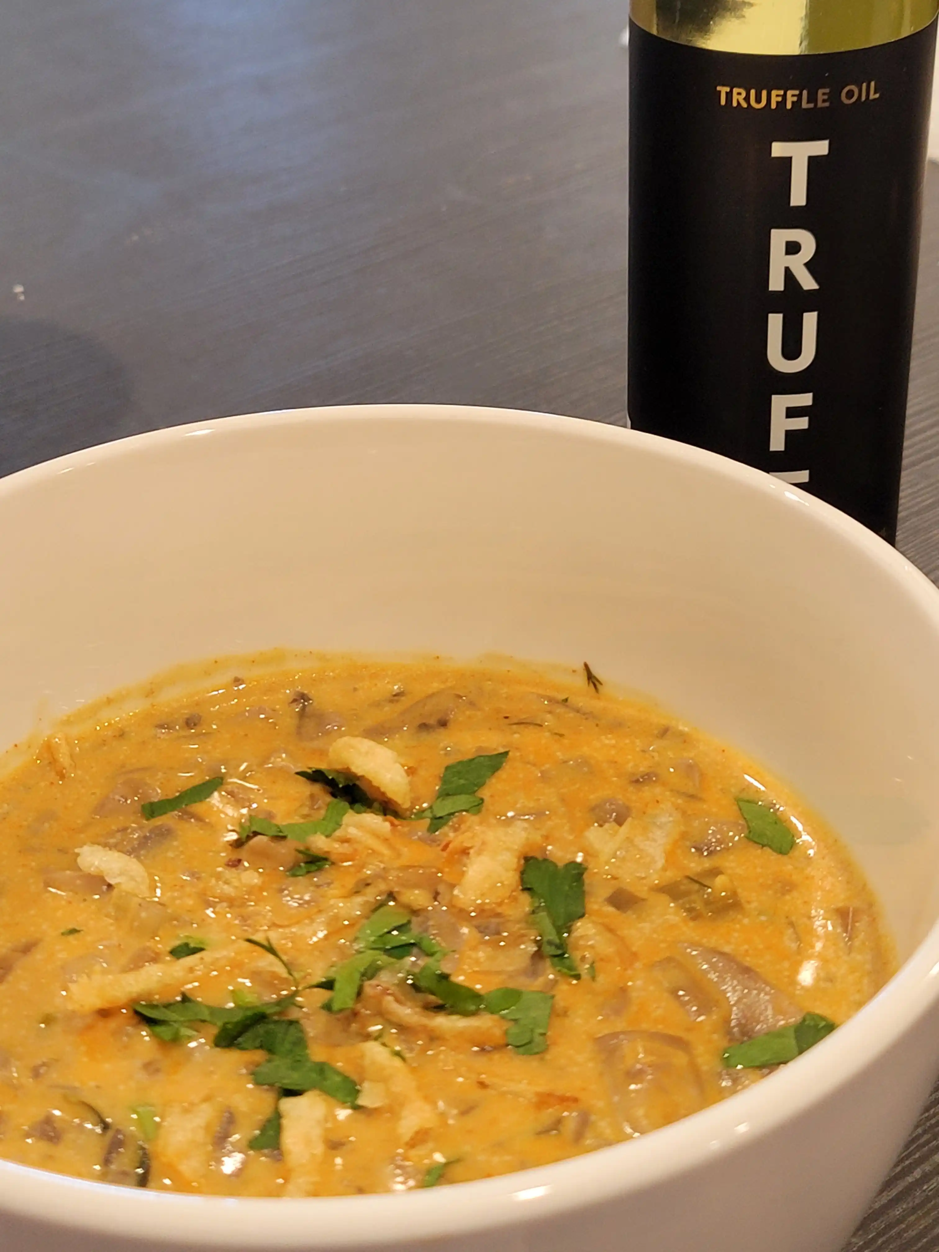 Gourmet Mushroom Soup served in a bowl with truffle oil garnish