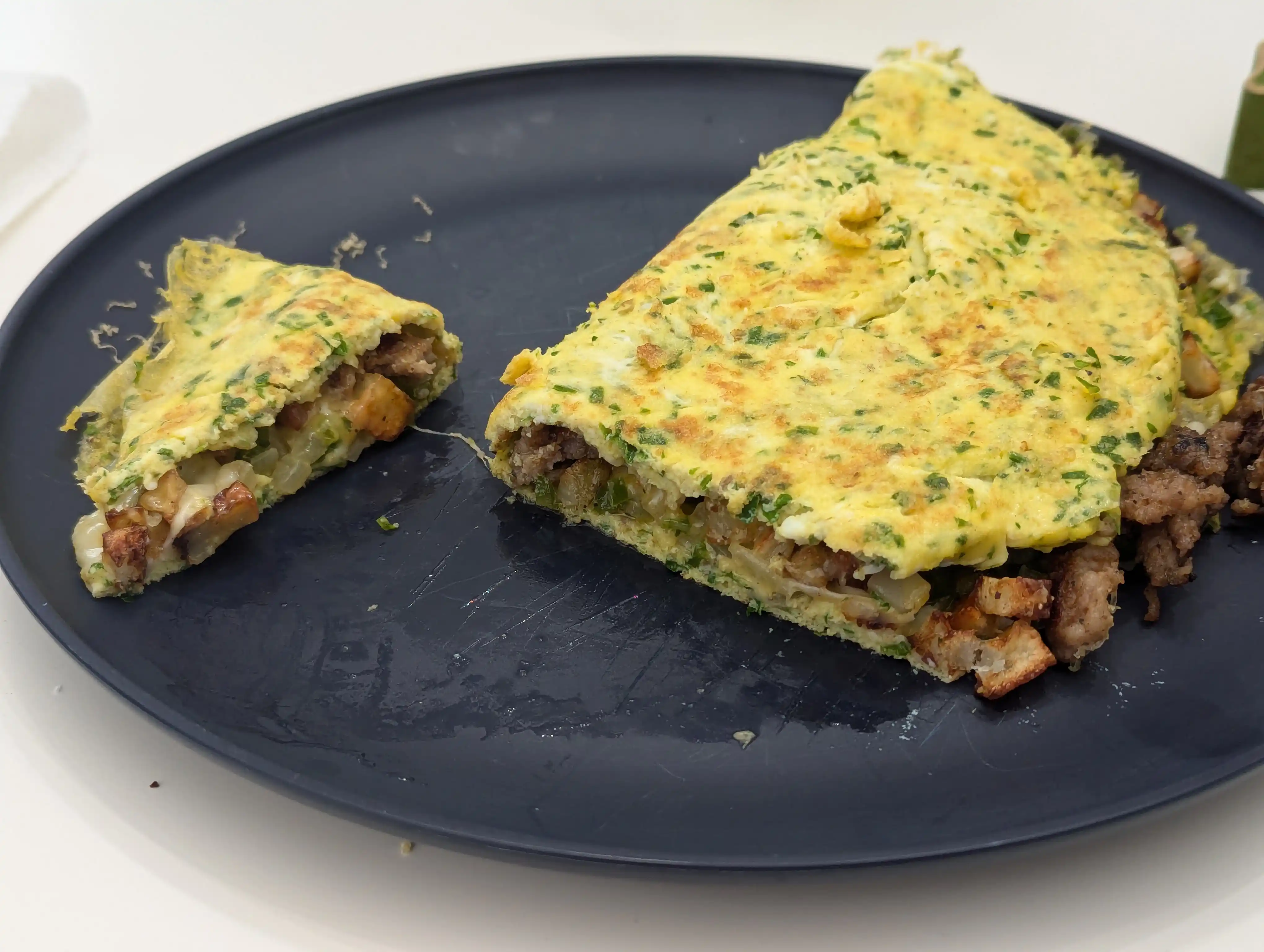 Omelette with sausage, jalapeno, onion, asiago, and cheddar