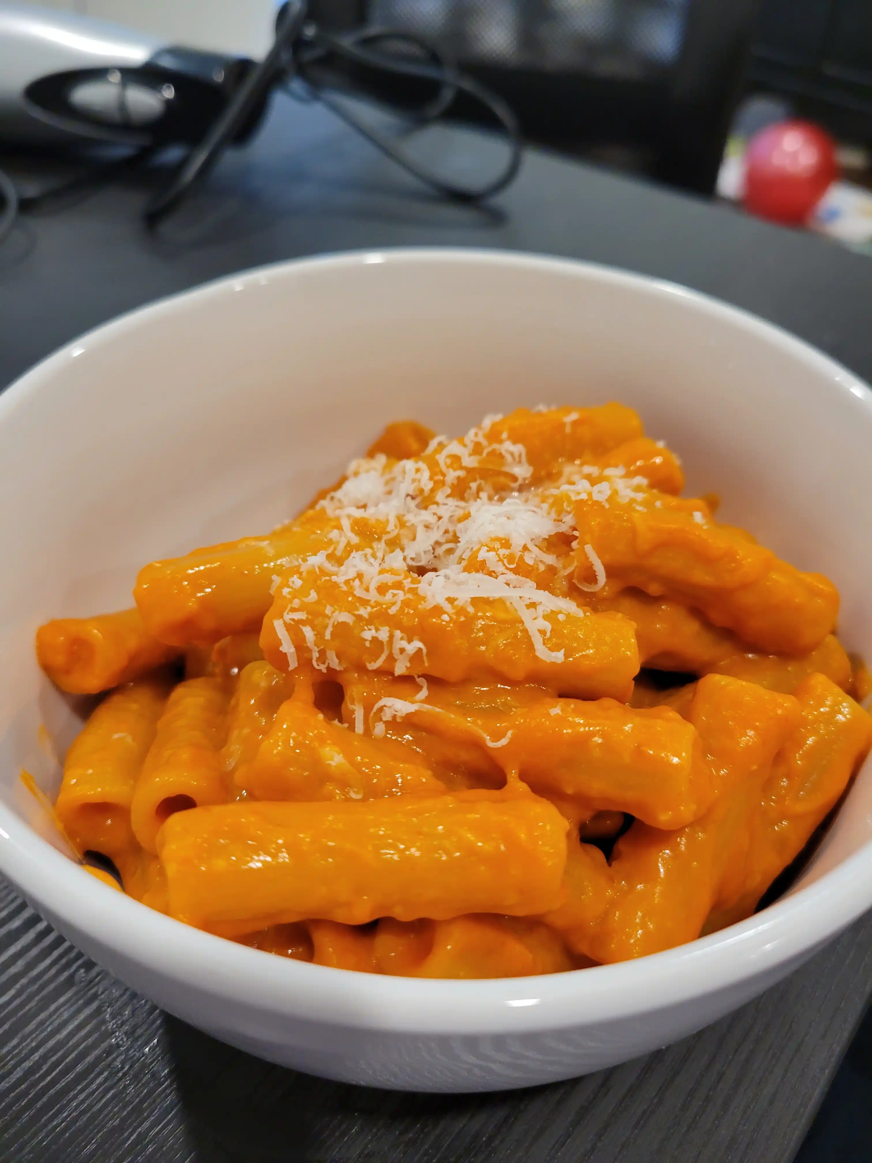 Penne alla vodka served with garnish of parmesan